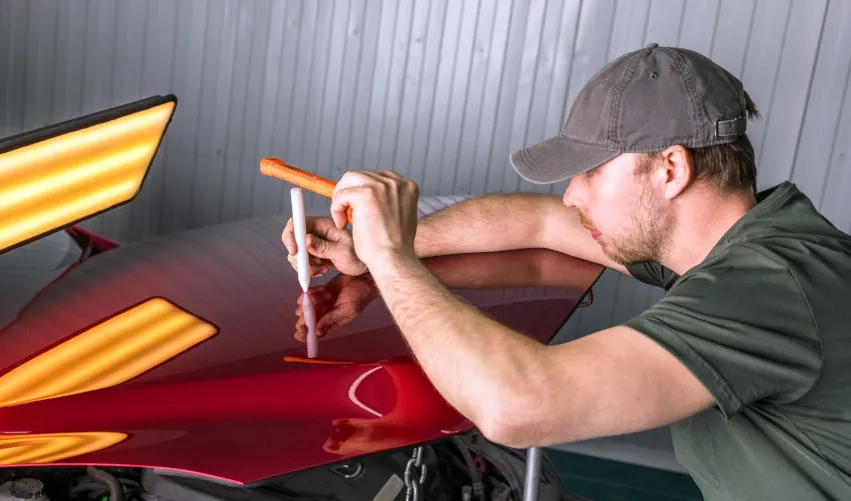 PDR Technician removing dents