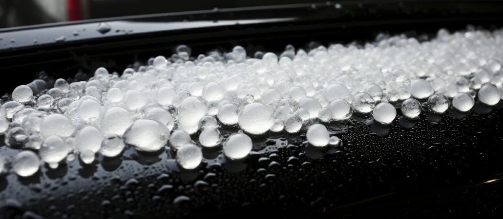 Vehicle parked on side of road during hail storm